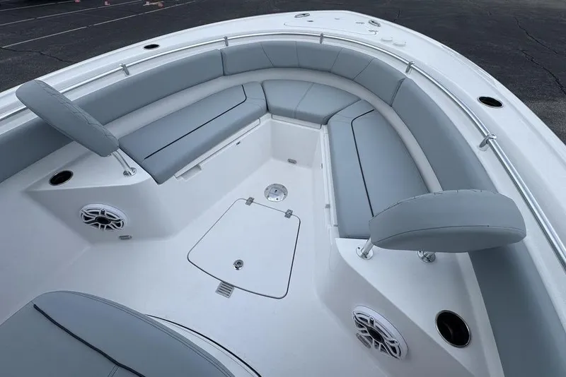 Slide: The Image of 2026 Sportsman Heritage 231 Center Console boat interior with gray seating and speakers. - 22