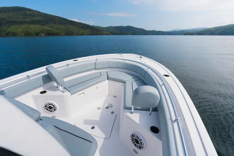 Slide: The Image of 2026 Sportsman Heritage 231 Center Console boat on serene lake with scenic mountain backdrop. - 26