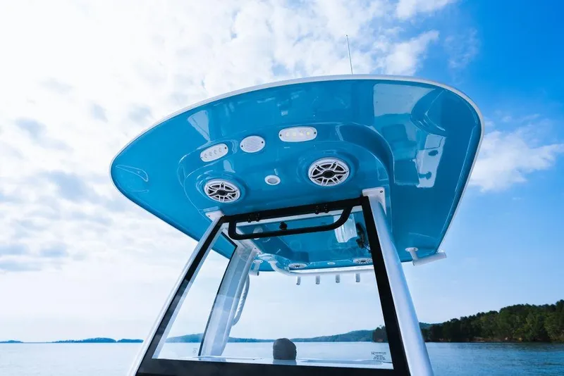 Slide: The Image of 2026 Sportsman Heritage 231 Center Console boat, blue canopy, scenic water view. - 30