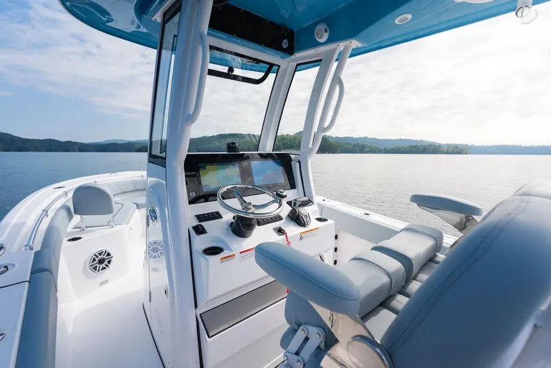Slide: The Image of 2026 Sportsman Heritage 231 Center Console boat interior on a serene lake. - 31