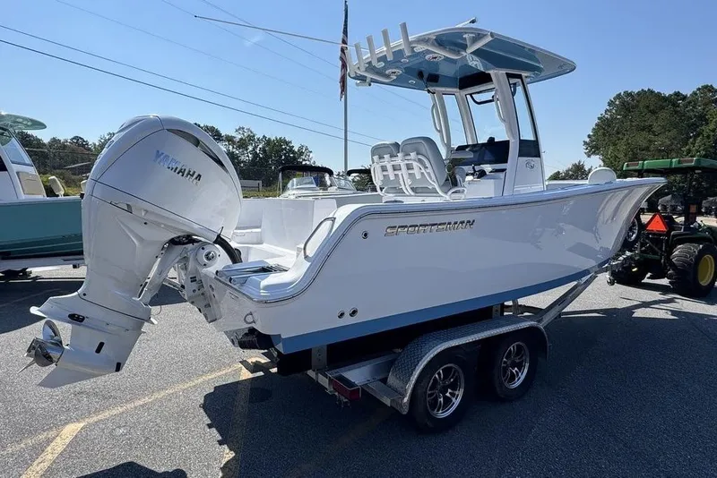 Slide: The Image of 2026 Sportsman Heritage 231 Center Console boat on trailer, parked outdoors. - 6