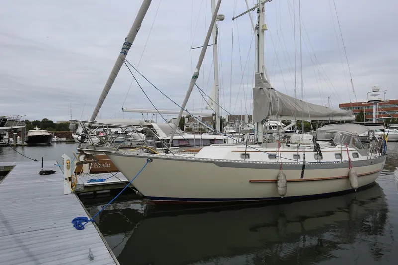 The Image of 2004 Pacific Seacraft 40 sailboat docked at marina, overcast sky, calm water. - 0