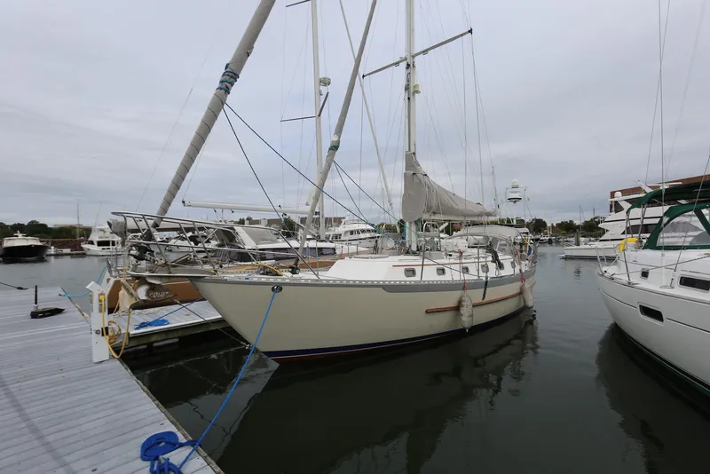 Slide: The Image of 2004 Pacific Seacraft 40 sailboat docked in a marina, surrounded by other boats. - 1