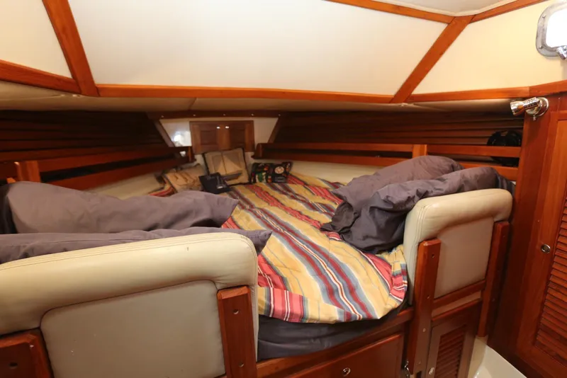 Slide: The Image of Cozy cabin interior of 2004 Pacific Seacraft 40 sailboat with striped bedding. - 11