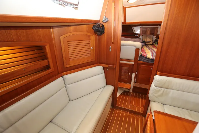 Slide: The Image of Interior of 2004 Pacific Seacraft 40 sailboat with wooden finish and cozy seating area. - 15