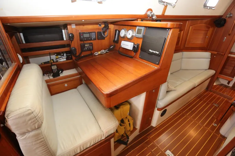 Slide: The Image of Interior of 2004 Pacific Seacraft 40 sailboat with navigation station and seating area. - 20