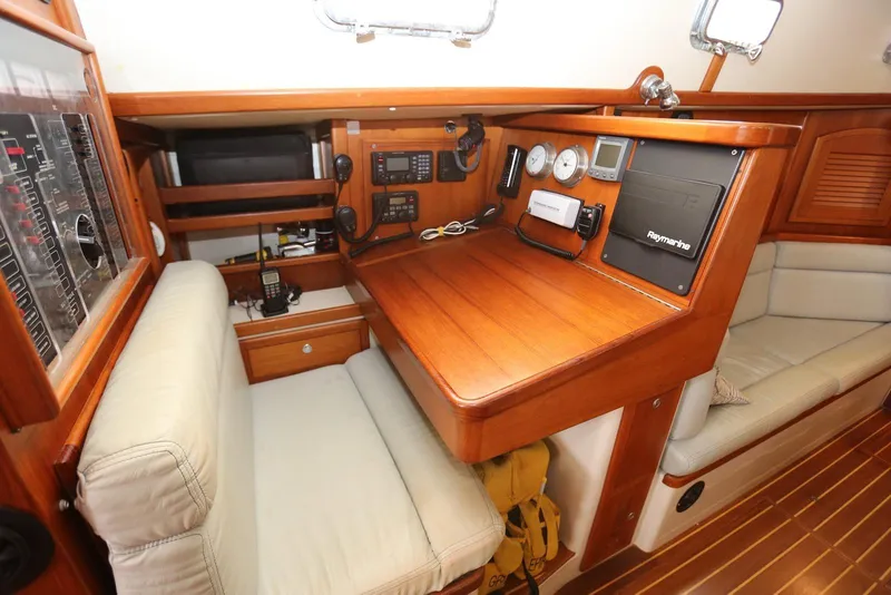Slide: The Image of Navigation station of 2004 Pacific Seacraft 40 sailboat with wood finish and modern instruments. - 21