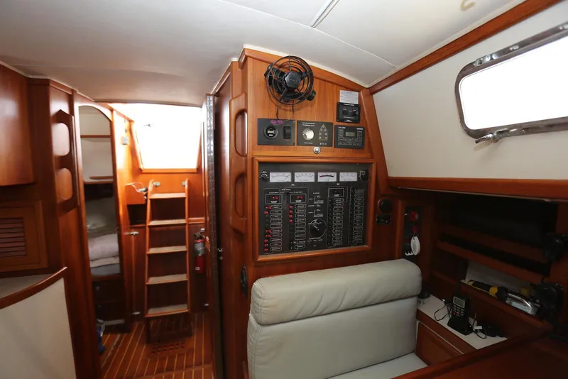Slide: The Image of Interior of 2004 Pacific Seacraft 40 sailboat with control panel and wooden finish. - 23