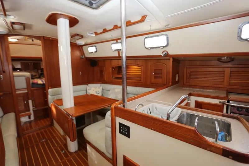 Slide: The Image of Interior of 2004 Pacific Seacraft 40 sailboat with wood finish and cozy seating area. - 29