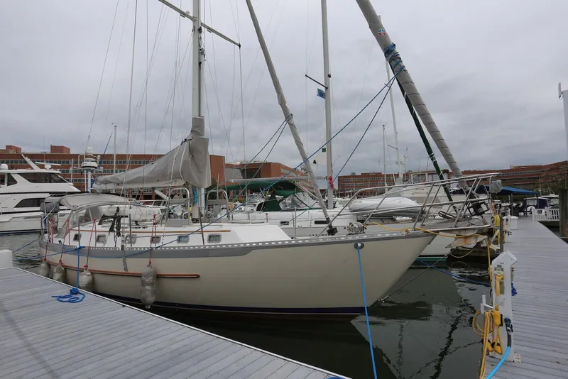 Slide: The Image of 2004 Pacific Seacraft 40 sailboat docked at marina on a cloudy day. - 3