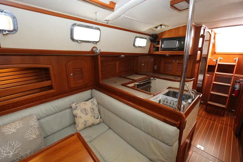 Slide: The Image of Interior of 2004 Pacific Seacraft 40 sailboat with cozy seating and wooden cabinetry. - 32