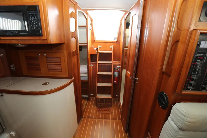 Slide: The Image of Interior of 2004 Pacific Seacraft 40 sailboat with wooden cabinetry and compact kitchen area. - 36