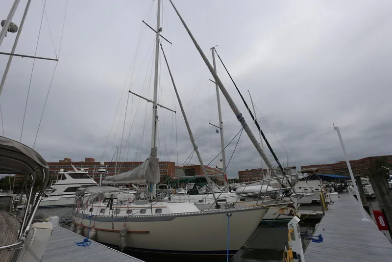 Slide: The Image of 2004 Pacific Seacraft 40 sailboat docked at a marina under cloudy skies. - 4