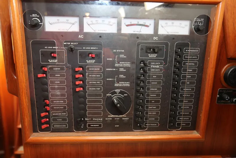 Slide: The Image of Electrical control panel on a 2004 Pacific Seacraft 40 sailboat, featuring AC and DC switches. - 43