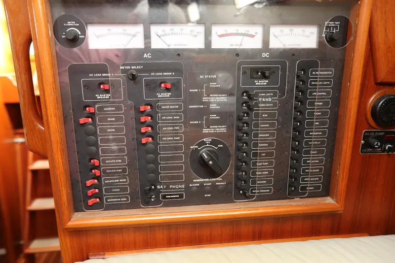 Slide: The Image of Electrical control panel on a 2004 Pacific Seacraft 40 sailboat, featuring AC and DC switches. - 44