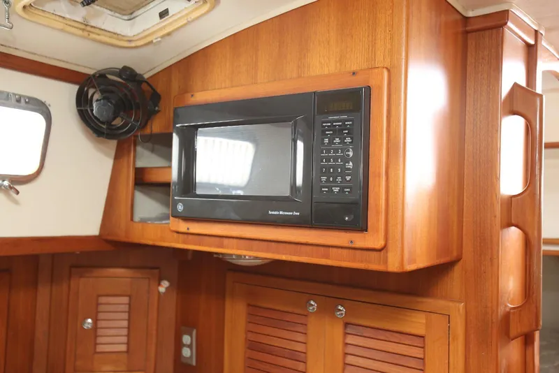 Slide: The Image of Wooden interior of 2004 Pacific Seacraft 40 yacht with built-in microwave. - 46