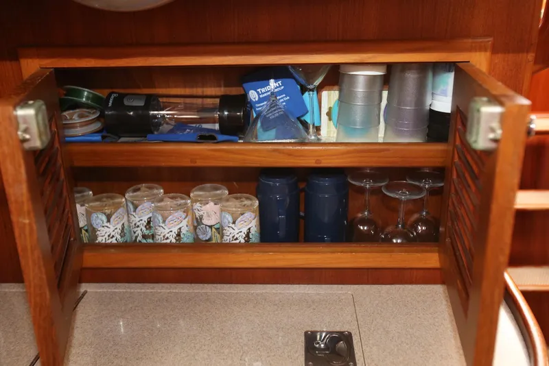Slide: The Image of Cabinet interior on 2004 Pacific Seacraft 40 yacht, featuring glasses and kitchenware. - 56