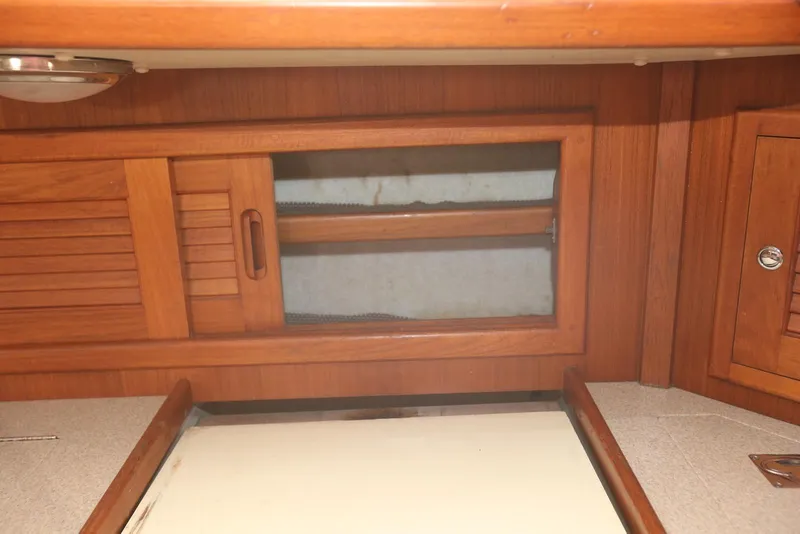 Slide: The Image of Interior of 2004 Pacific Seacraft 40 sailboat with wooden cabinetry and sliding doors. - 58