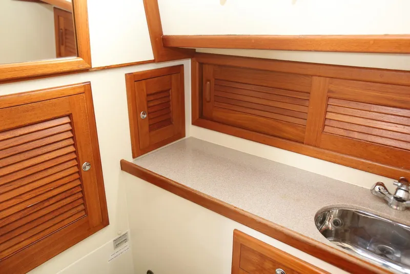 Slide: The Image of Interior of 2004 Pacific Seacraft 40 yacht with wooden cabinets and stainless steel sink. - 62