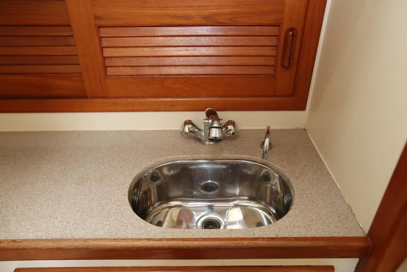 Slide: The Image of Stainless steel sink in 2004 Pacific Seacraft 40 yacht with wooden cabinetry. - 65
