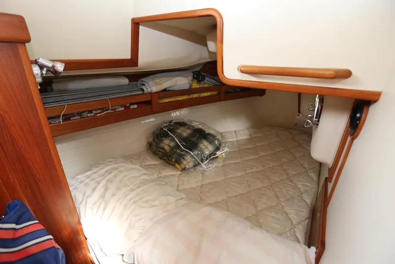 Slide: The Image of Cozy cabin interior of 2004 Pacific Seacraft 40 sailboat with bedding and storage. - 68