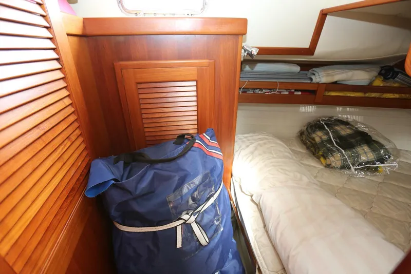 Slide: The Image of Cozy cabin interior of 2004 Pacific Seacraft 40 sailboat with bedding and storage. - 69