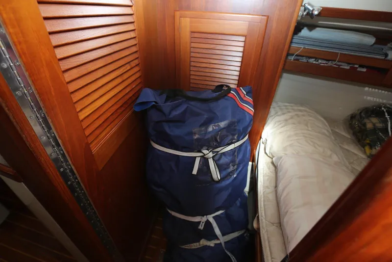 Slide: The Image of Blue duffel bag in wooden cabin of 2004 Pacific Seacraft 40 sailboat. - 70