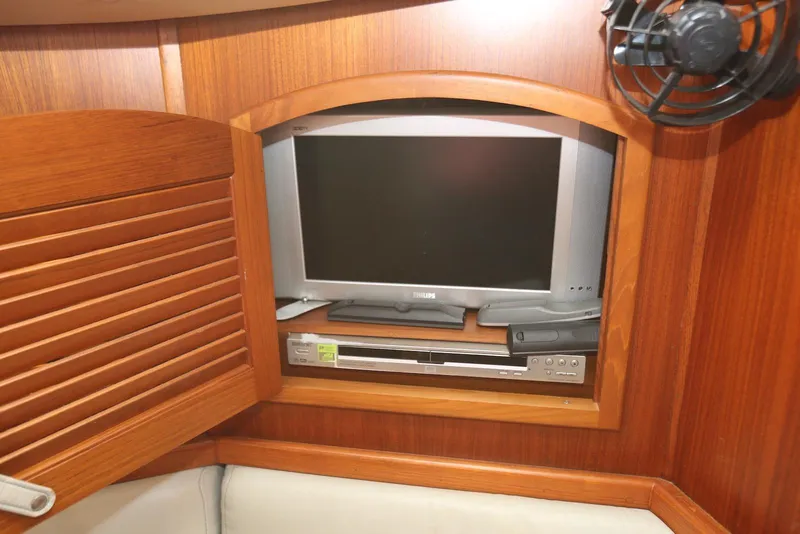 Slide: The Image of 2004 Pacific Seacraft 40 interior with TV and DVD player in wooden cabinet. - 71