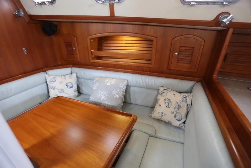 Slide: The Image of Cozy interior of 2004 Pacific Seacraft 40 sailboat with cushioned seating and wooden table. - 73
