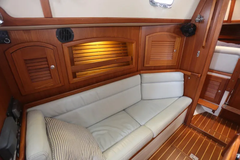Slide: The Image of Interior of 2004 Pacific Seacraft 40 sailboat with wooden cabinetry and cushioned seating. - 74
