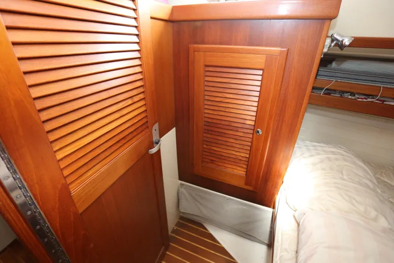 Slide: The Image of Interior of 2004 Pacific Seacraft 40 sailboat with wooden cabinetry and cozy sleeping area. - 80