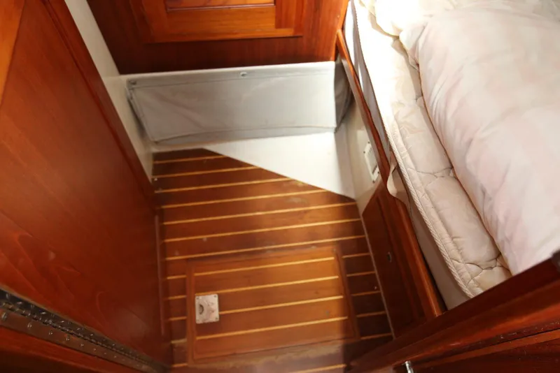 Slide: The Image of Interior of 2004 Pacific Seacraft 40 sailboat with wooden flooring and cozy bedding. - 81