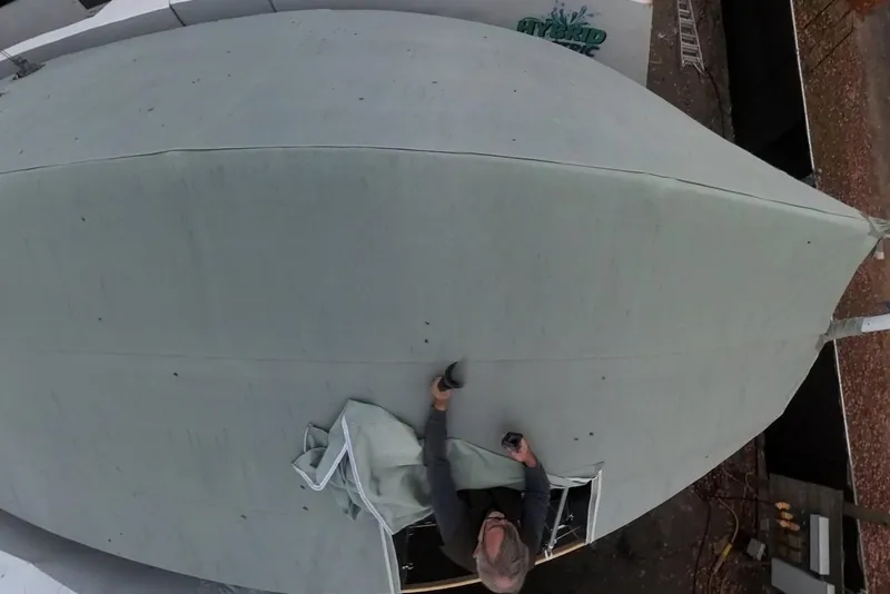 Slide: The Image of Aerial view of a person working on a 2004 Pacific Seacraft 40 sailboat. - 84