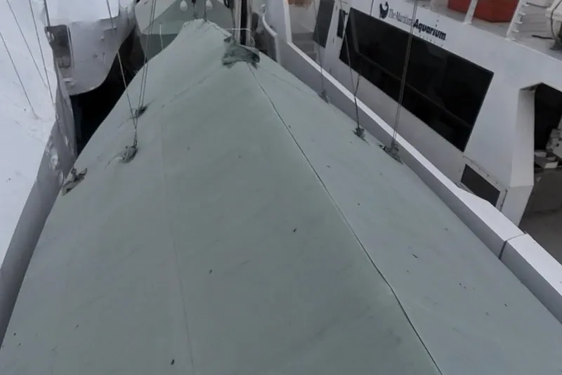 Slide: The Image of Covered deck of a 2004 Pacific Seacraft 40 sailboat in a marina. - 85