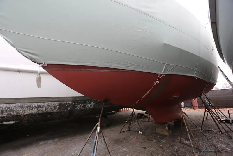 Slide: The Image of 2004 Pacific Seacraft 40 sailboat on stands, covered and ready for maintenance. - 88