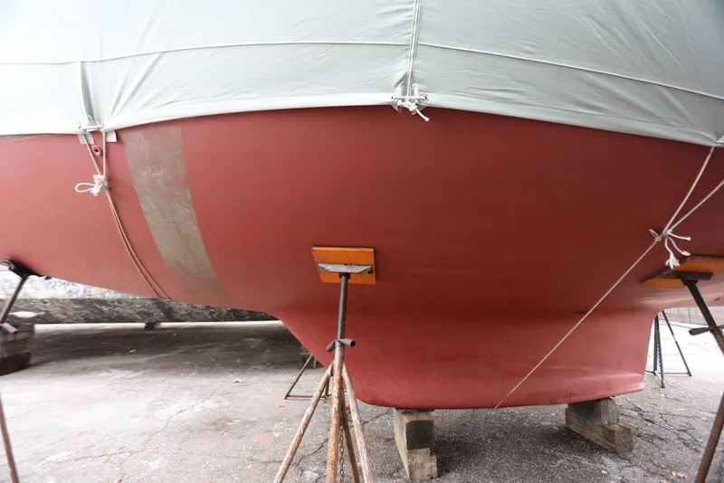 Slide: The Image of 2004 Pacific Seacraft 40 sailboat hull on stands, covered and secured. - 89