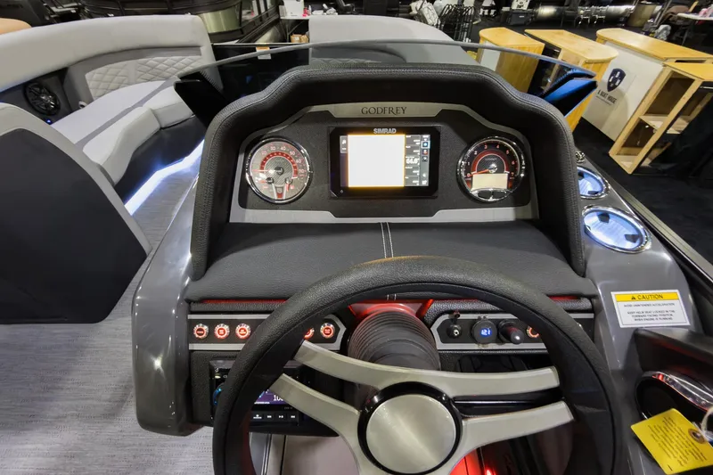 Slide: The Image of 2026 Godfrey Monaco 235 Ultra Lounge dashboard with modern controls and steering wheel. - 12