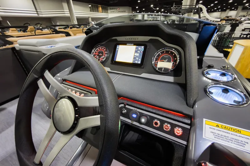 Slide: The Image of 2026 Godfrey Monaco 235 Ultra Lounge dashboard with steering wheel and control panel. - 14