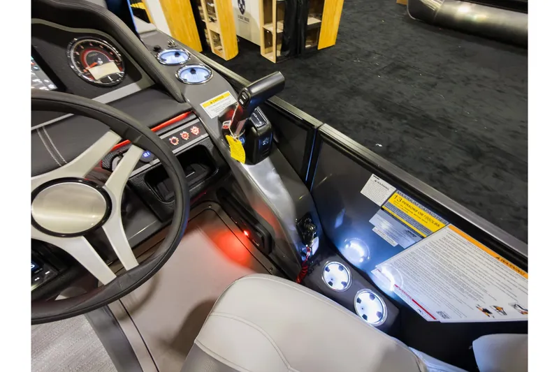 Slide: The Image of Interior of 2026 Godfrey Monaco 235 Ultra Lounge boat, featuring steering wheel and control panel. - 15