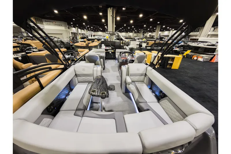 Slide: The Image of 2026 Godfrey Monaco 235 Ultra Lounge boat interior at a showroom, featuring luxurious seating. - 27