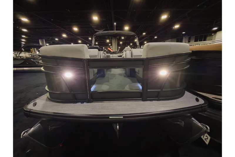 Slide: The Image of 2026 Godfrey Monaco 235 Ultra Lounge pontoon boat with illuminated deck in showroom. - 4