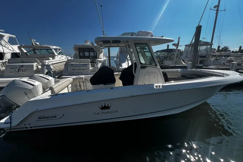The Image of 2022 Boston Whaler 280 Outrage boat docked in marina, side view. - 0
