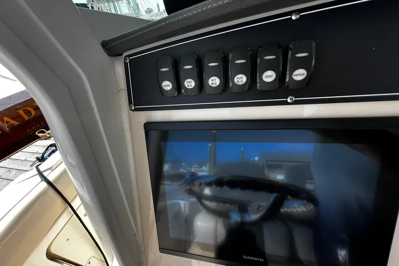 Slide: The Image of Control panel and display on a 2022 Boston Whaler 280 Outrage boat. - 10