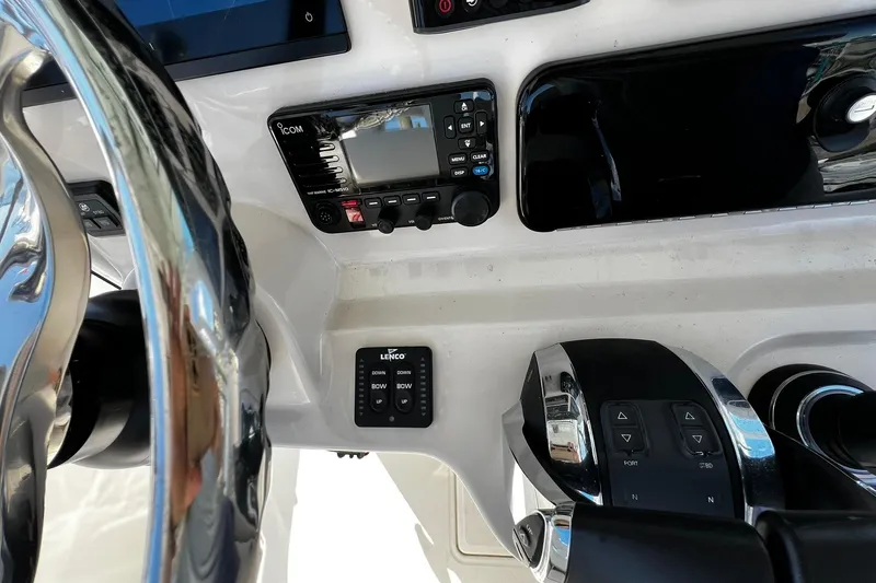 Slide: The Image of Control panel of 2022 Boston Whaler 280 Outrage boat, featuring steering wheel and electronic controls. - 13