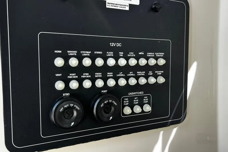 Slide: The Image of Control panel of a 2022 Boston Whaler 280 Outrage boat, featuring various switches and dials. - 18