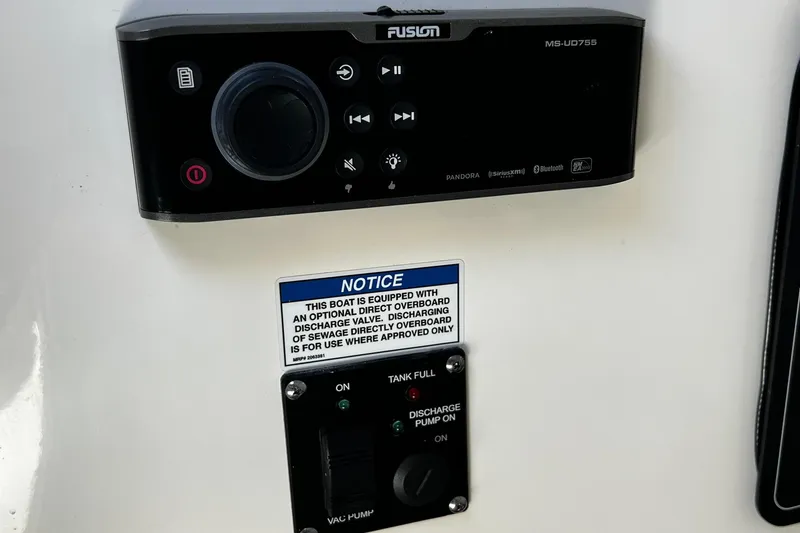 Slide: The Image of Control panel on 2022 Boston Whaler 280 Outrage with audio system and discharge notice. - 19