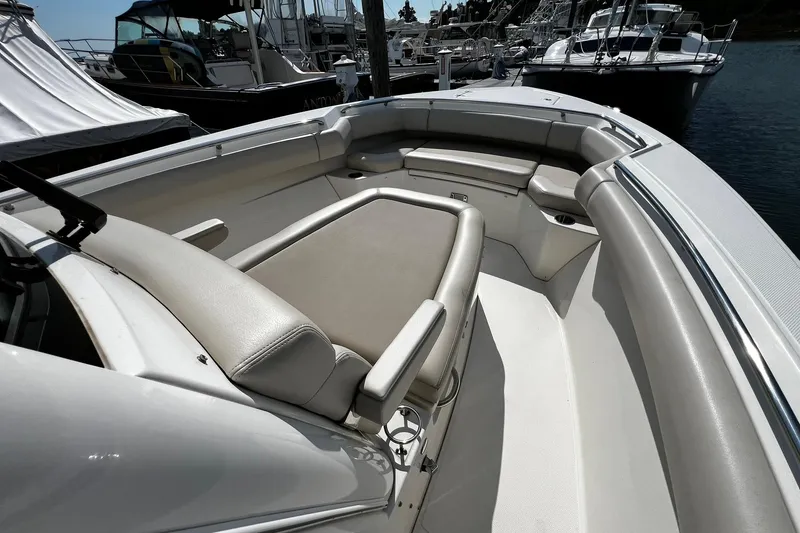 Slide: The Image of 2022 Boston Whaler 280 Outrage boat interior with cushioned seating and sleek design. - 20