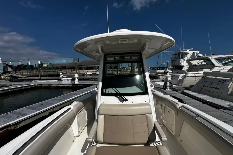 Slide: The Image of 2022 Boston Whaler 280 Outrage boat docked at marina under clear blue sky. - 22