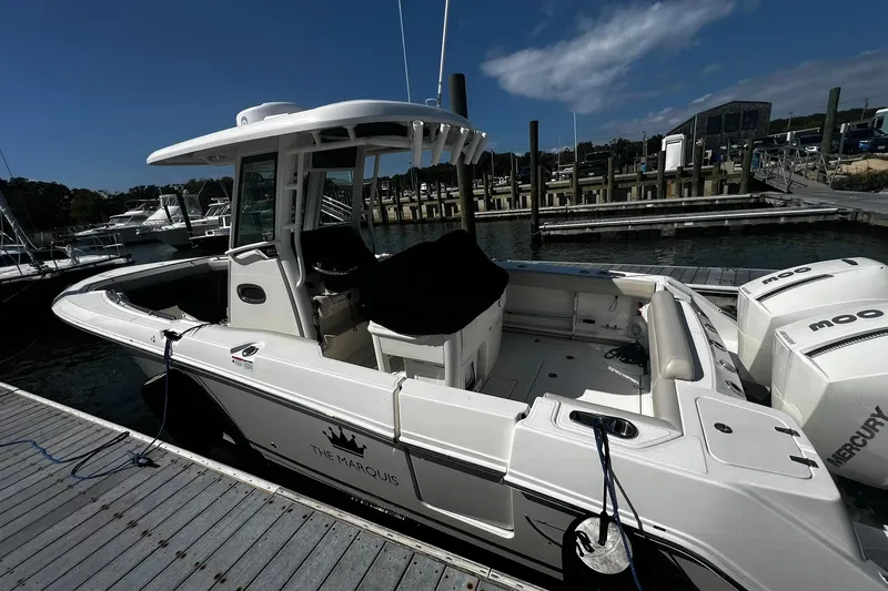 Slide: The Image of 2022 Boston Whaler 280 Outrage docked at marina under clear blue sky. - 25