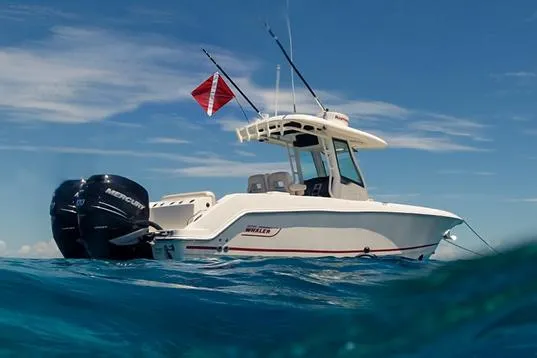 Slide: The Image of Manufacturer Provided Image: 2022 Boston Whaler 280 Outrage boat on open water with fishing rods and flag. - 28